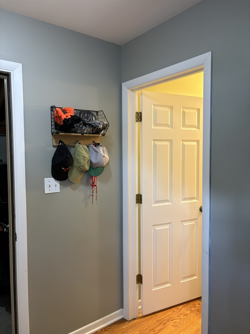 609 West Gartner Road Naperville, IL 60540 - Photo 12 of 23 a view of a room that has a bench and hardwood floor
