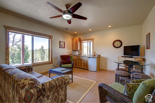 1735 West Pinyon Hls Road Hatch, UT 84735 - Photo 11 of 21 Spacious room featuring a ceiling fan, recessed lighting, and large windows with wood trim