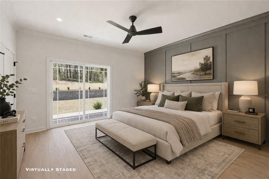 1121 Riverside Terrace Gainesville, GA 30501 - Photo 22 of 39 a spacious bedroom with a bed a couch and a large window