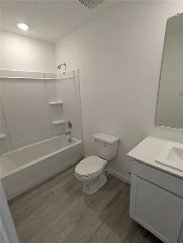 a bathroom with a toilet a sink and a bathtub