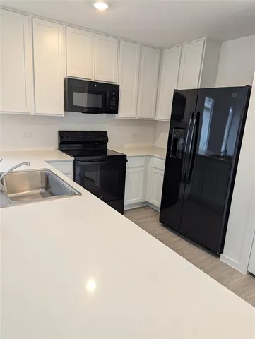 a kitchen with a refrigerator and a sink