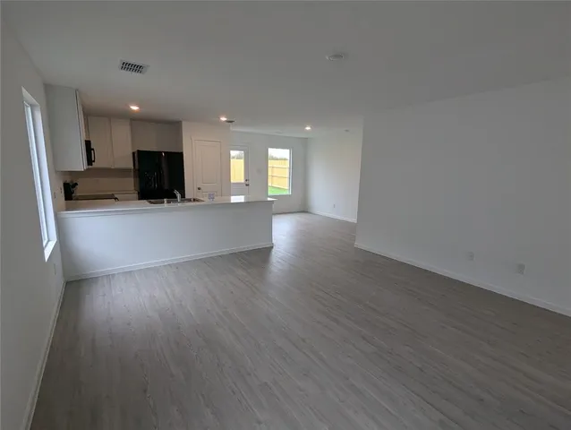a view of a kitchen with a sink and a large window