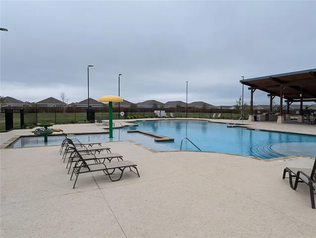 a view of a swimming pool with lounge chairs