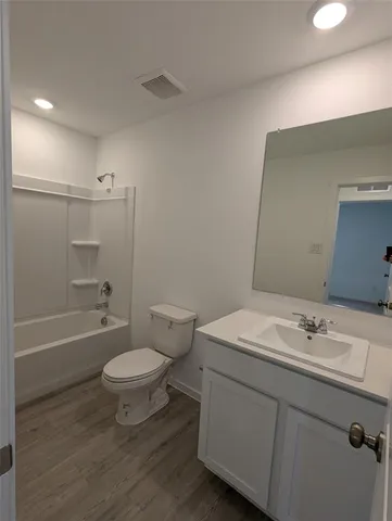 a bathroom with a sink mirror toilet and bathtub
