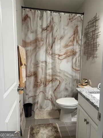 a white toilet sitting next to a shower curtain