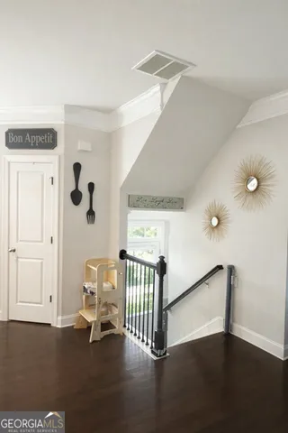 a view of a hallway with entryway wooden floor and front door