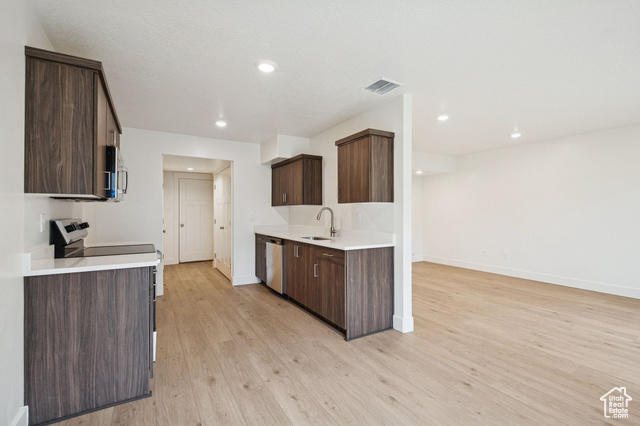 1615 North Angel Street, Unit E Layton, UT 84041 - Photo 12 of 42 Kitchen with dark brown cabinets, stainless steel appliances, light wood-style flooring, modern cabinets, and recessed lighting