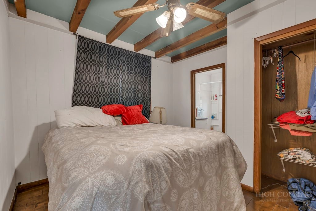 179 Soave Ridge Deep Gap, NC 28618 - Photo 16 of 31 a bedroom with a bed and a chandelier