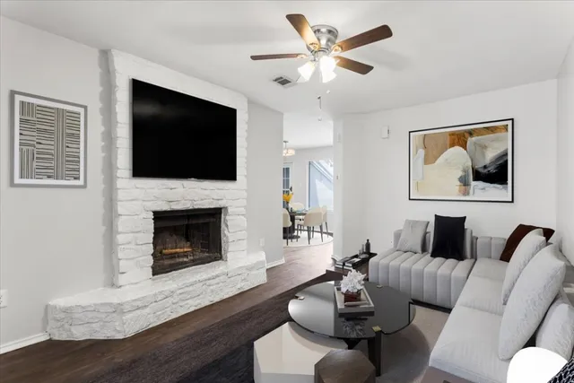a living room with furniture a flat screen tv and a fireplace