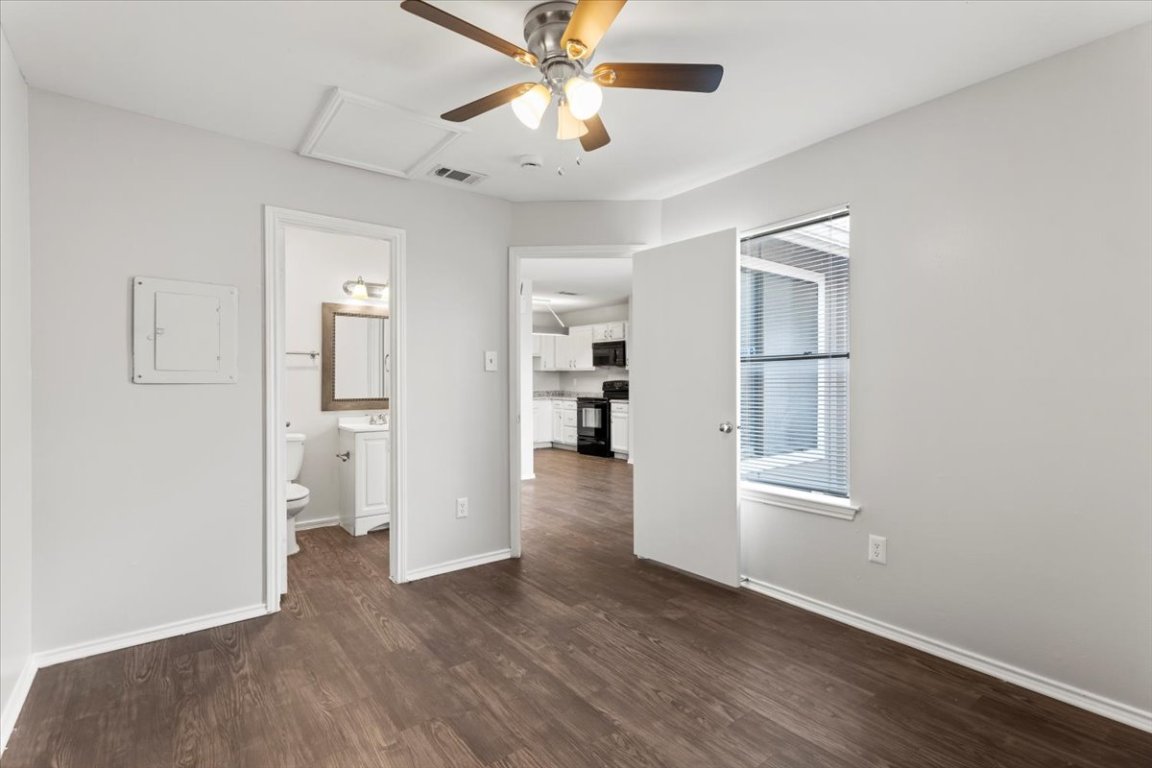 1740 Timber Ridge Road, Unit 132 Austin, TX 78741 - Photo 19 of 29 wooden floor in an empty room with a window