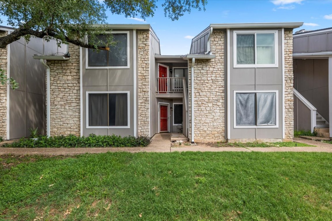 1740 Timber Ridge Road, Unit 132 Austin, TX 78741 - Photo 2 of 29 a front view of a house with garden