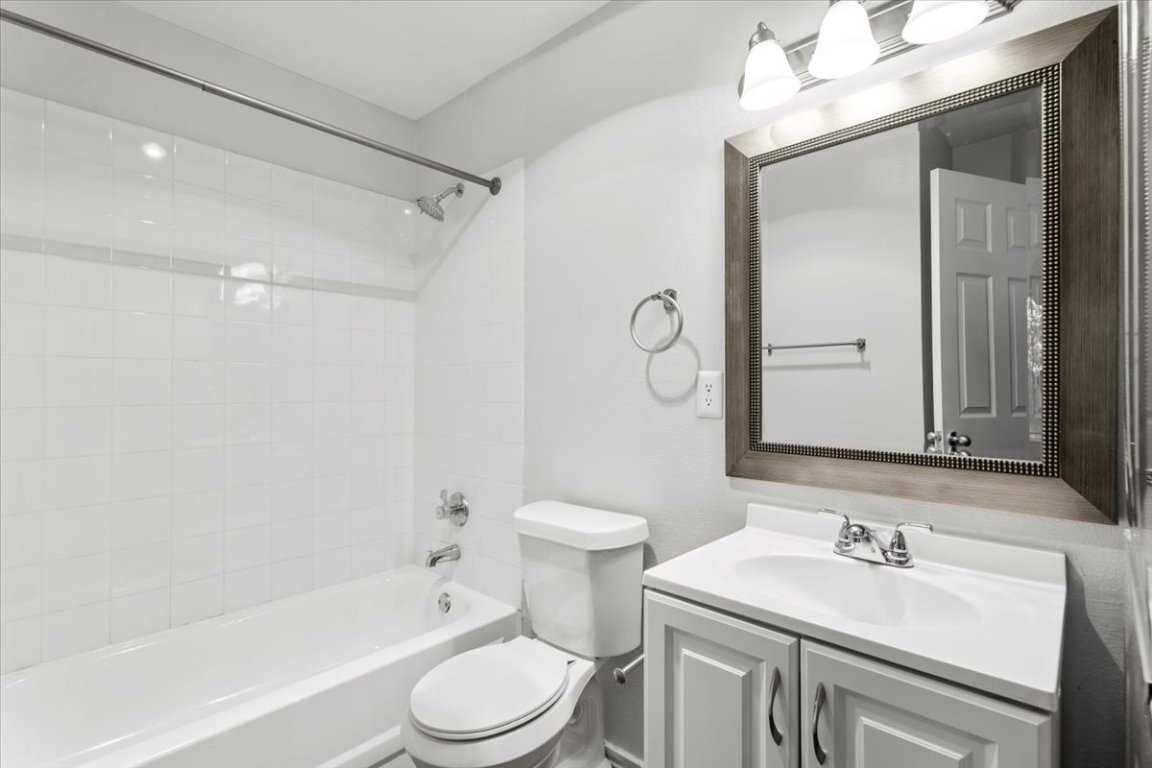 1740 Timber Ridge Road, Unit 132 Austin, TX 78741 - Photo 24 of 29 a bathroom with a sink a toilet and shower