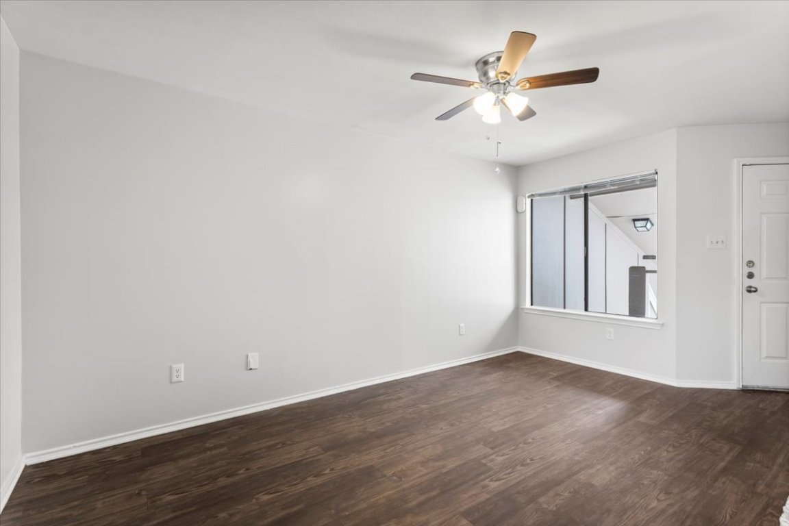 1740 Timber Ridge Road, Unit 132 Austin, TX 78741 - Photo 6 of 29 wooden floor in an empty room with a window