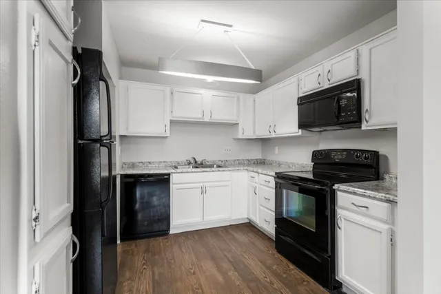 a kitchen with stainless steel appliances granite countertop a stove sink microwave and refrigerator