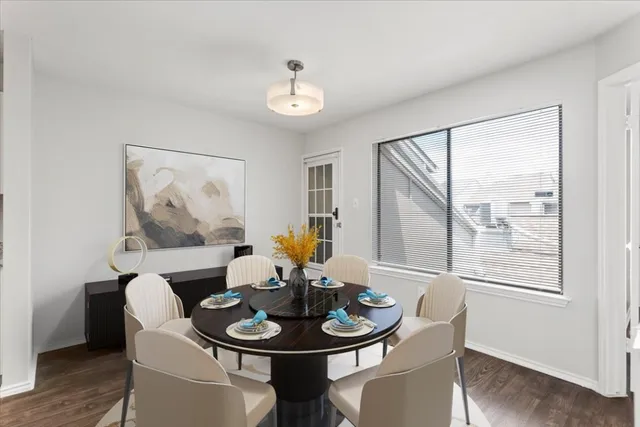 a dining room with furniture a window and wooden floor