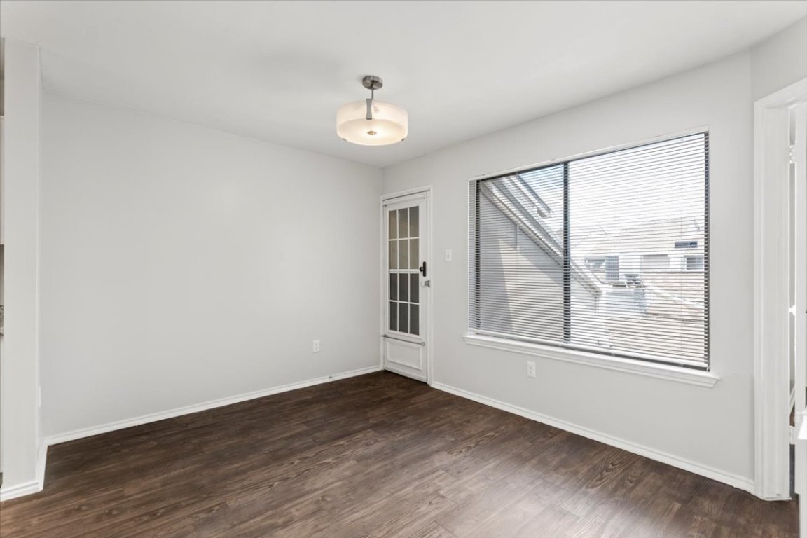 1740 Timber Ridge Road, Unit 132 Austin, TX 78741 - Photo 10 of 29 a view of an empty room with wooden floor and a window