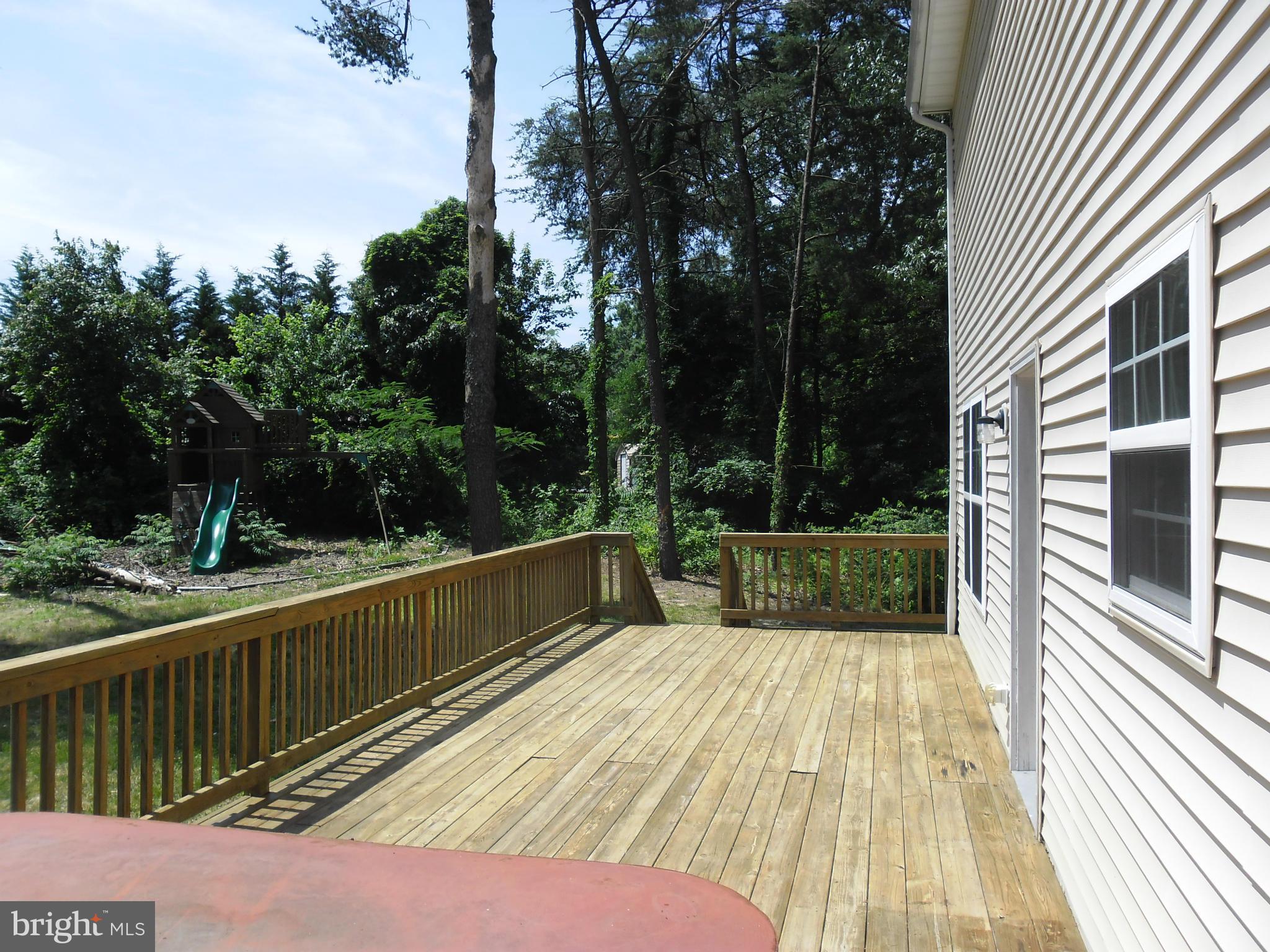 7833 Clark Station Road Severn, MD 21144 - Photo 13 of 30 a view of balcony with wooden floor and fence