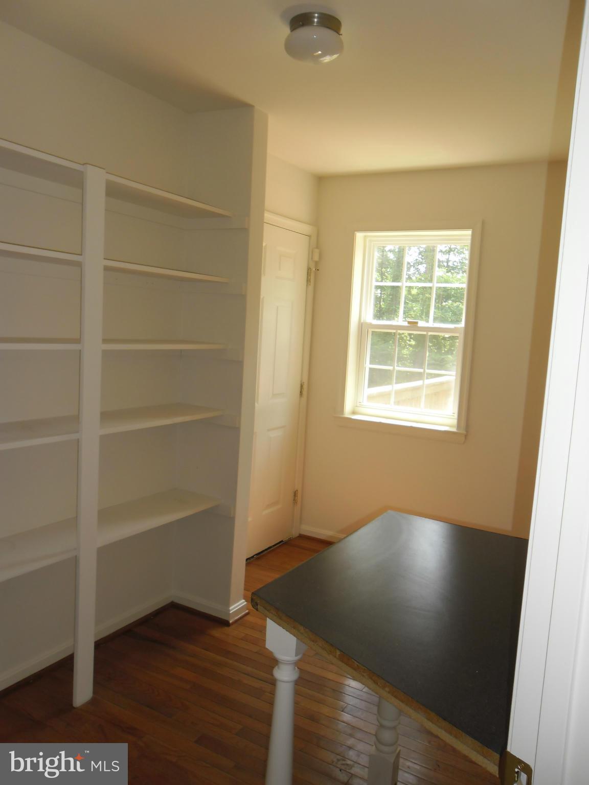 7833 Clark Station Road Severn, MD 21144 - Photo 22 of 30 a view of an empty room with wooden floor and a window
