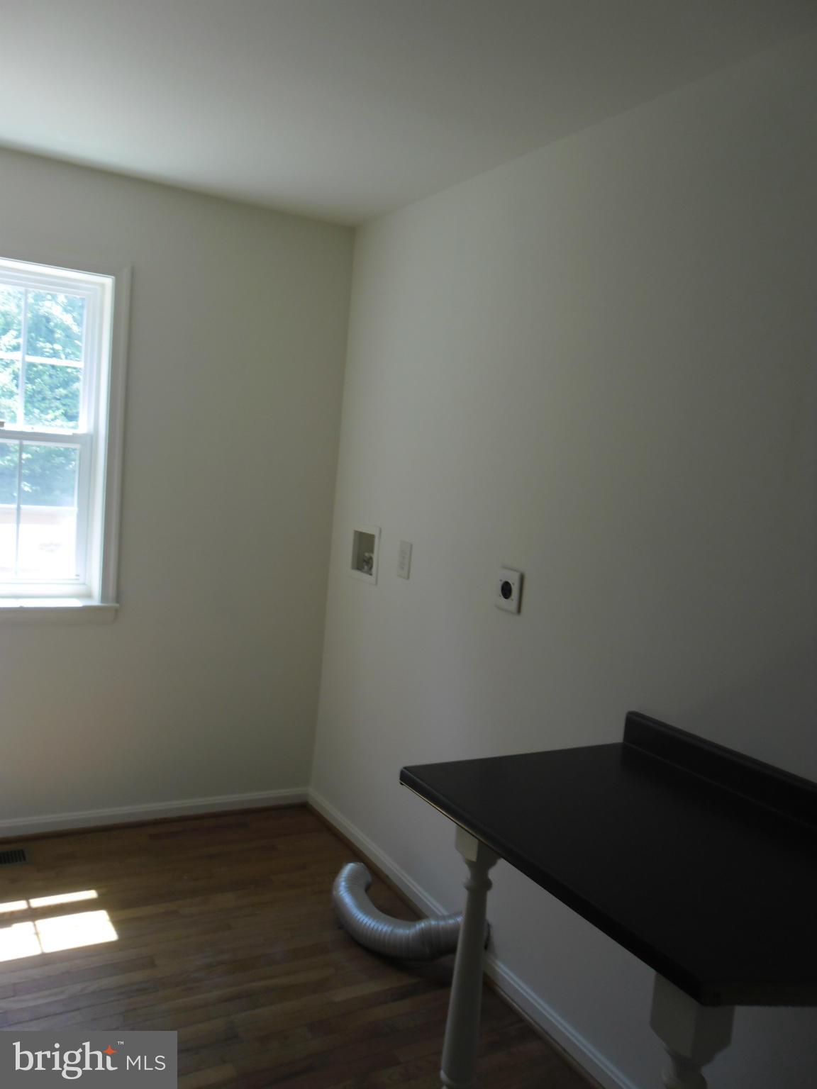 7833 Clark Station Road Severn, MD 21144 - Photo 23 of 30 a table and chair in a room