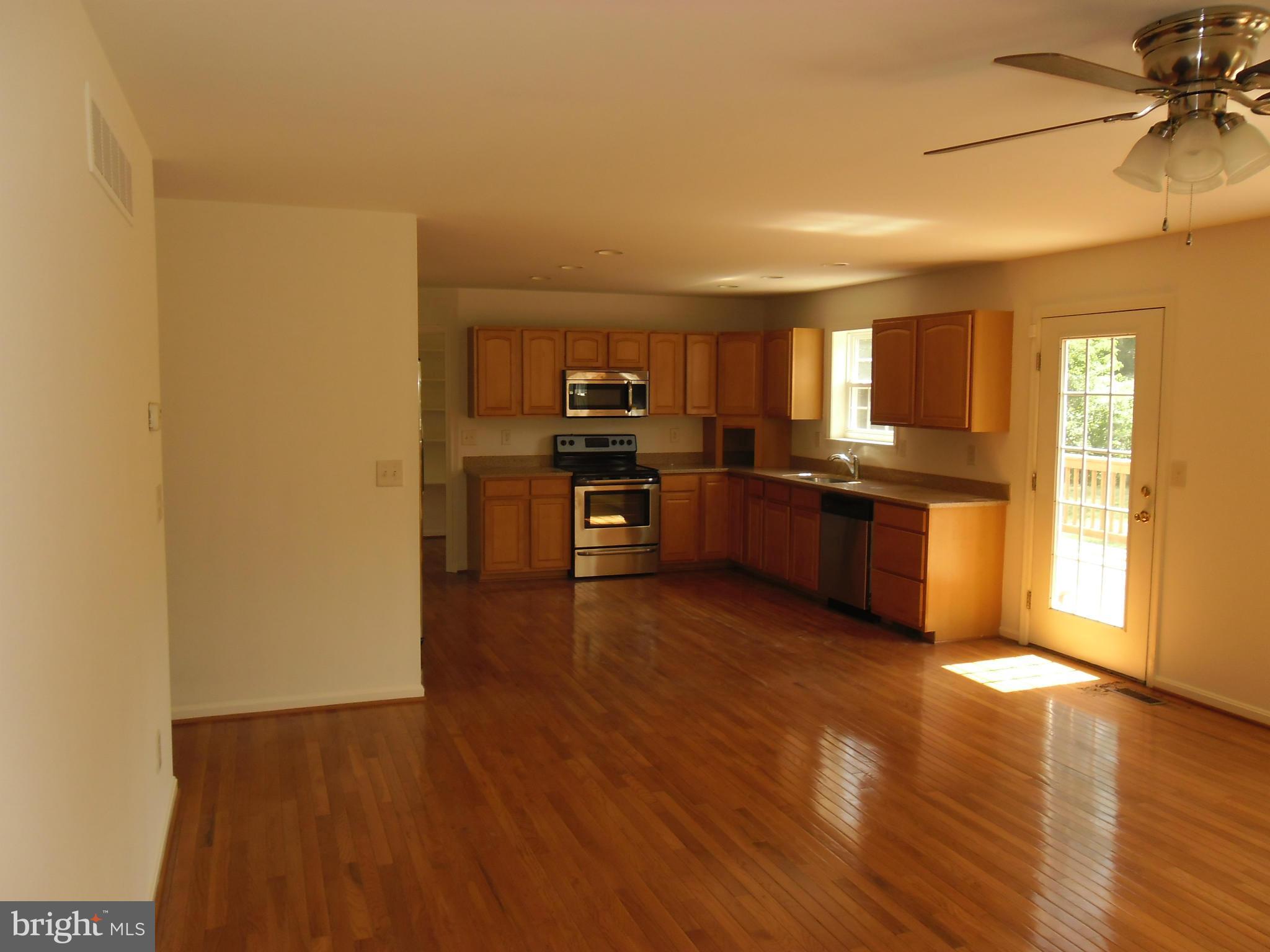 7833 Clark Station Road Severn, MD 21144 - Photo 6 of 30 a view of a kitchen with a sink stove cabinets and empty room