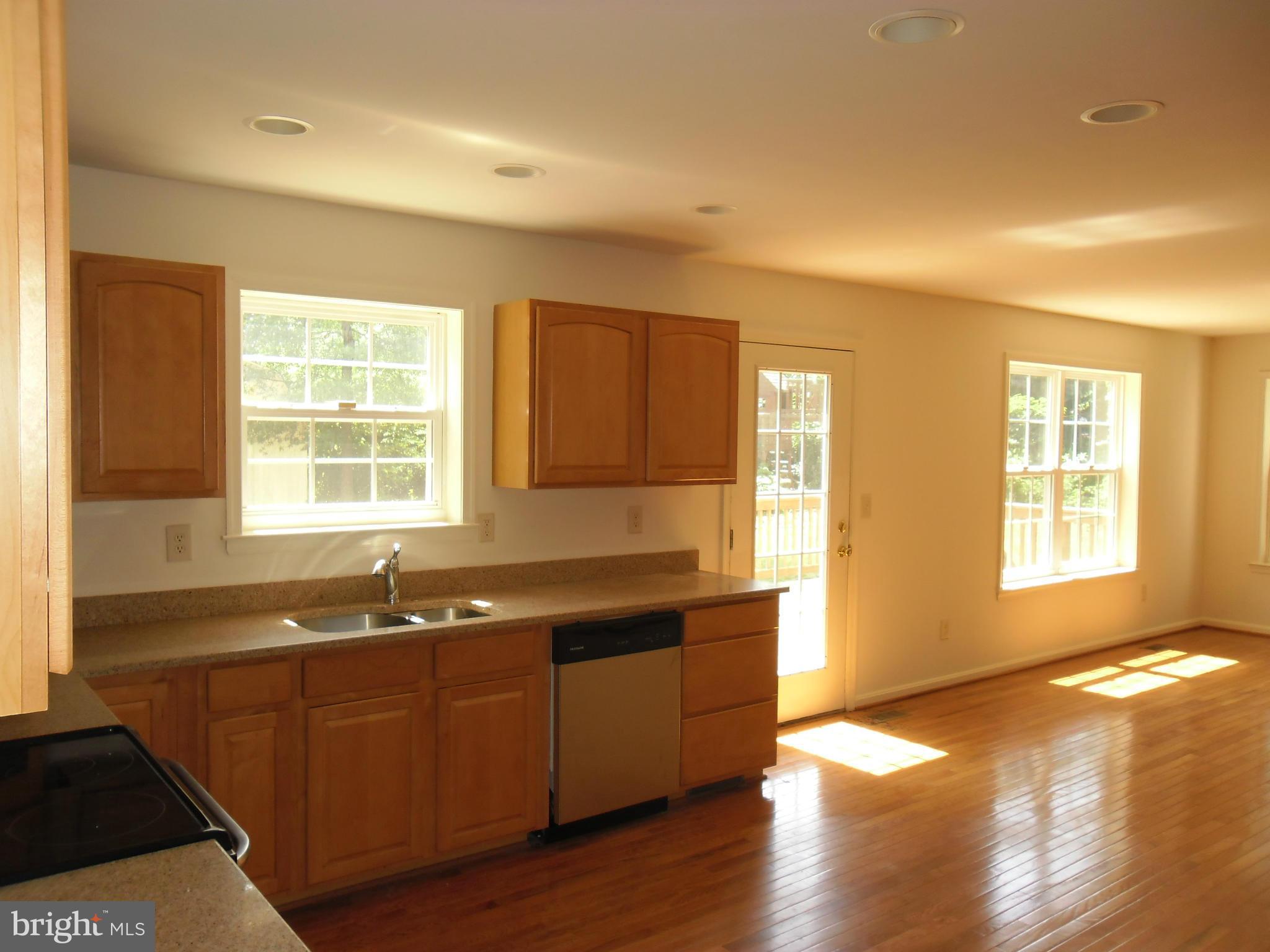 7833 Clark Station Road Severn, MD 21144 - Photo 7 of 30 a view of an empty room with wooden floor and a window
