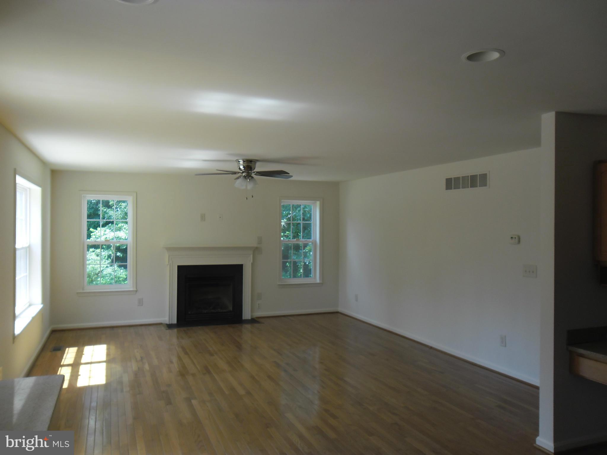 7833 Clark Station Road Severn, MD 21144 - Photo 10 of 30 an empty room with windows and fireplace