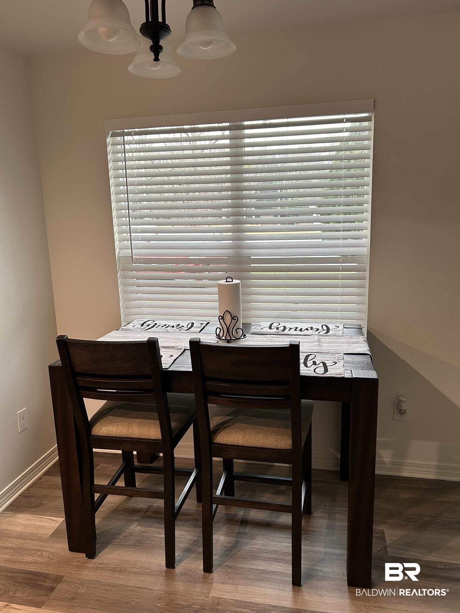 2 Canterberry Circle Foley, AL 36535 - Photo 19 of 24 Dining area with a chandelier, a healthy amount of sunlight, baseboards, and wood finished floors