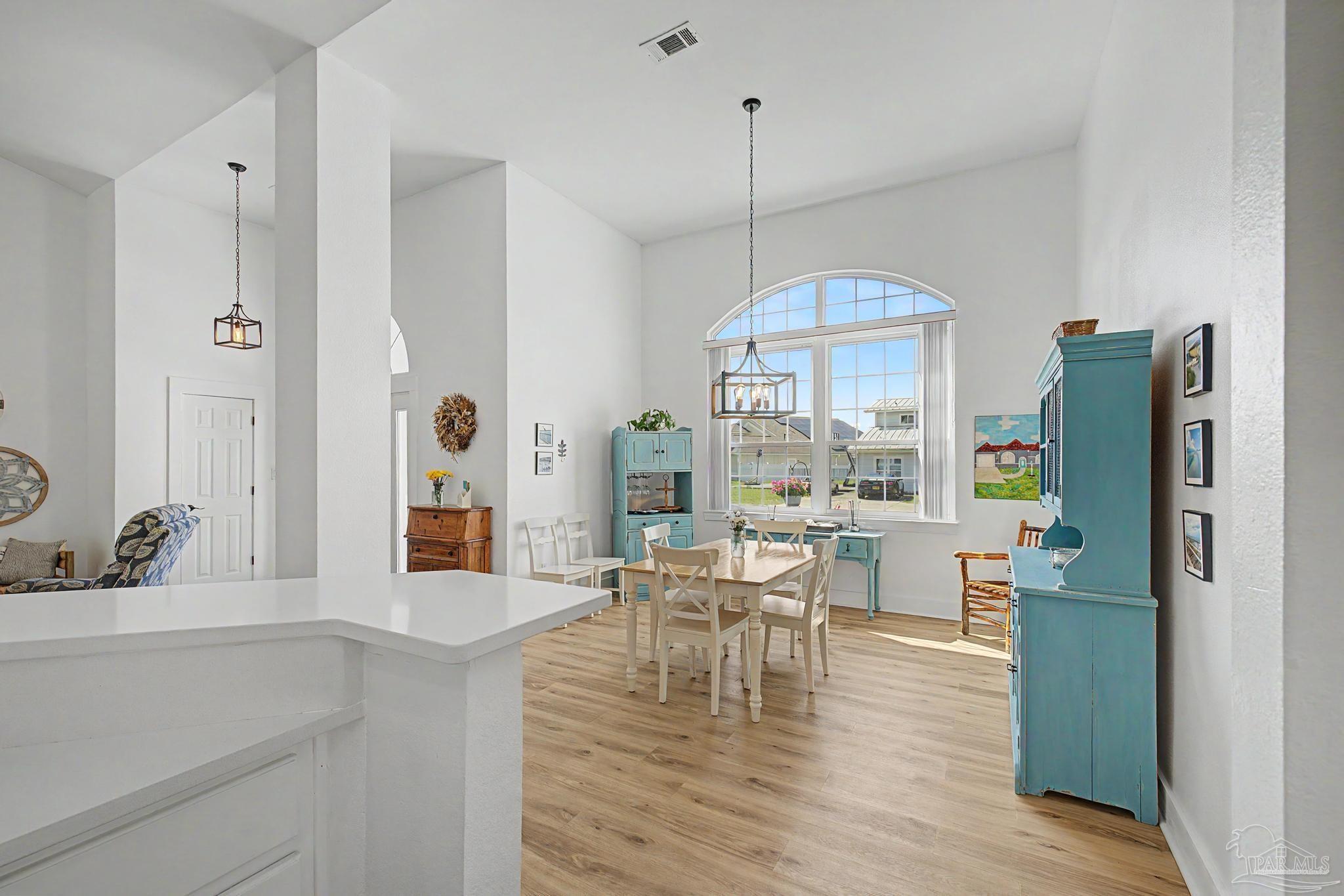 2005 Riviera Lane South Navarre, FL 32566 - Photo 15 of 70 a view of a dining room with furniture window and wooden floor