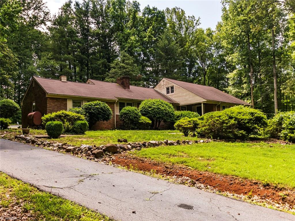 1812 Neelley Road Pleasant Garden, NC 27313 - Photo 22 of 26 This lovely home is it's own private oasis. Sitting on over 6 Acres this 3BR/2BA home offers two fire places, a driveway around the back of the home, a mudroom, laundry room and 1 big art studio and a storage building.