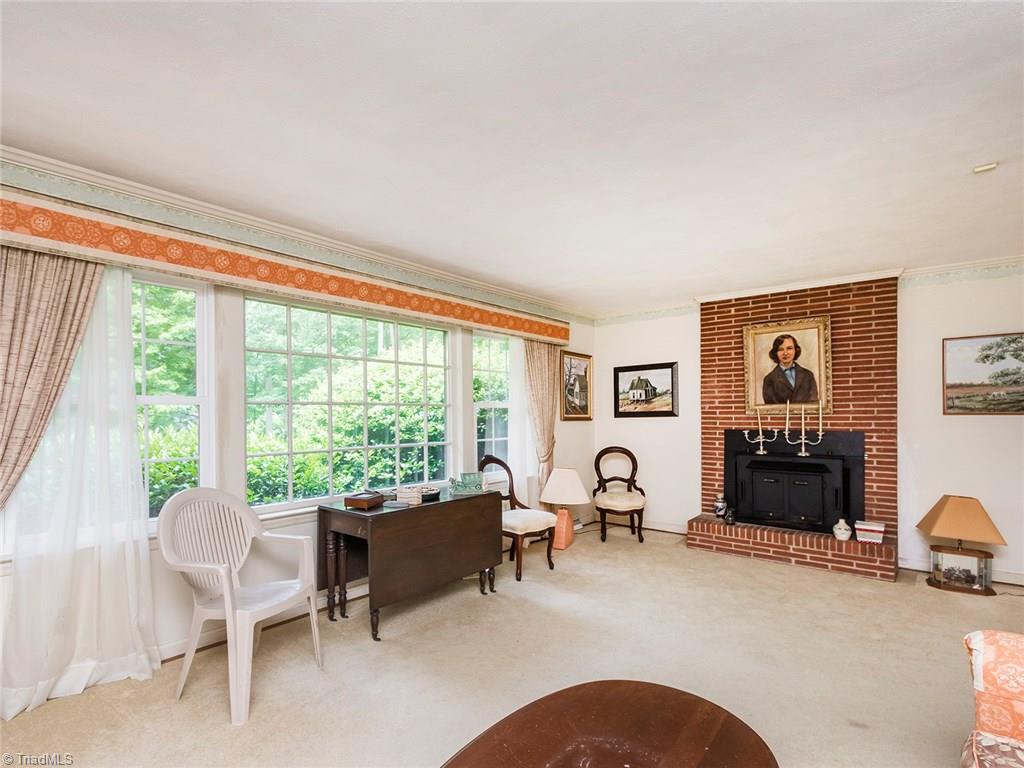 1812 Neelley Road Pleasant Garden, NC 27313 - Photo 4 of 26 The formal living room offers a beautiful brick fireplace, and large windows overlooking the large front yard.