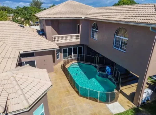 a view of a house with a backyard and porch