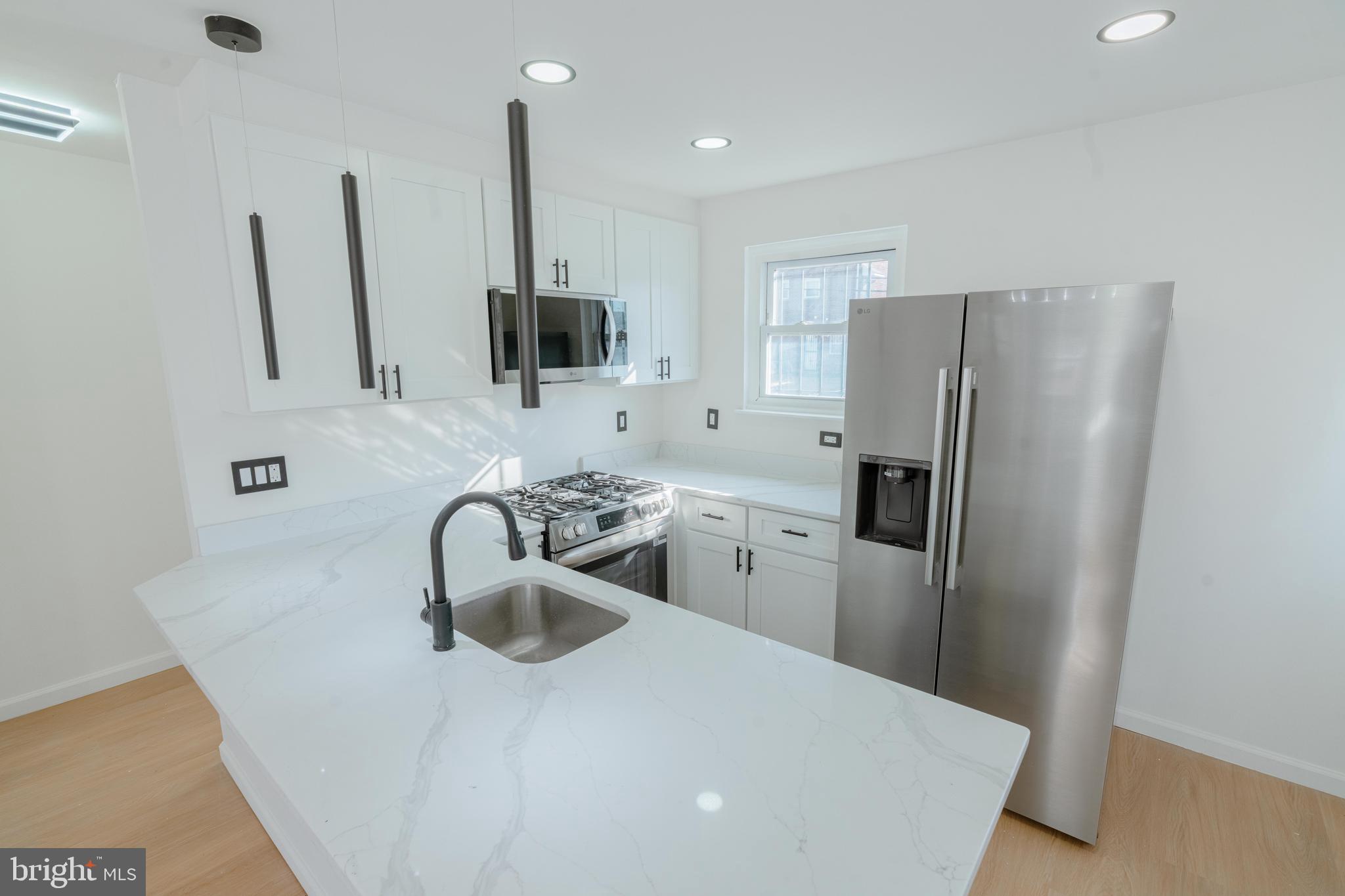 413 Kennedy Street Northeast Washington, DC 20011 - Photo 13 of 16 a kitchen with stainless steel appliances a refrigerator sink and microwave
