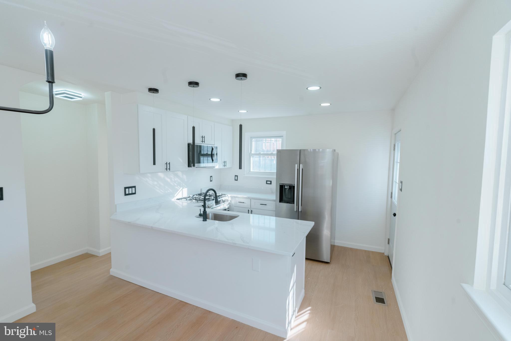 413 Kennedy Street Northeast Washington, DC 20011 - Photo 14 of 16 a view of a kitchen with a sink and refrigerator