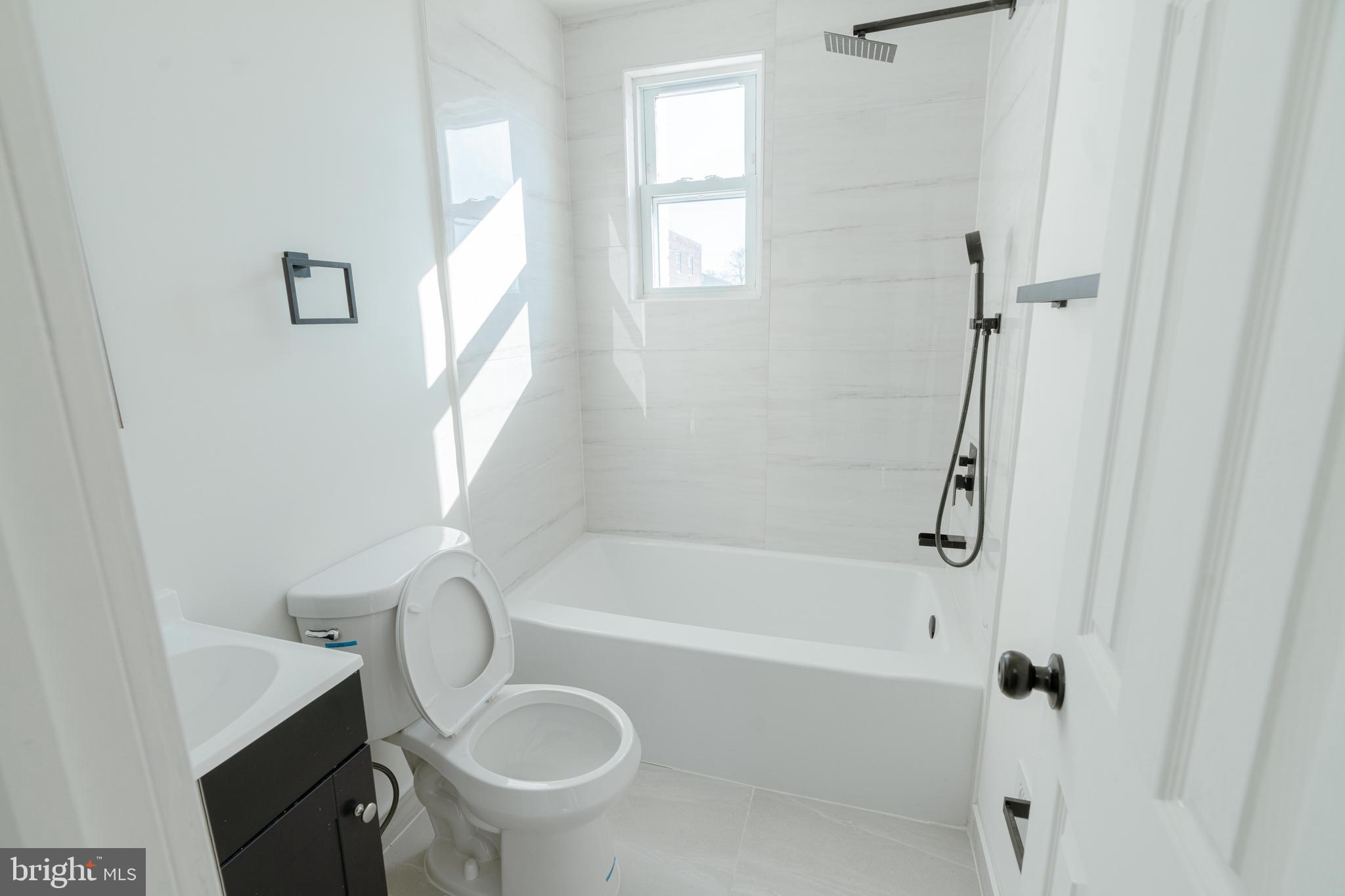 413 Kennedy Street Northeast Washington, DC 20011 - Photo 9 of 16 a bathroom with a sink a toilet and shower