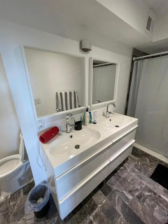 5140 Conroy Road, Unit 37 Orlando, FL 32811 - Photo 11 of 18 a bathroom with a sink and a mirror