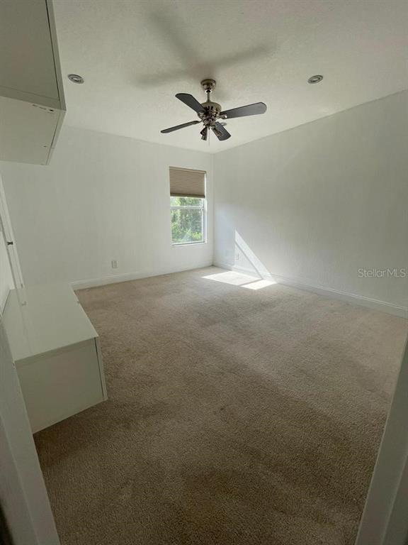 5140 Conroy Road, Unit 37 Orlando, FL 32811 - Photo 13 of 18 an empty room with windows and fan