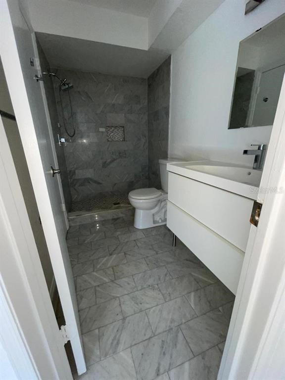 5140 Conroy Road, Unit 37 Orlando, FL 32811 - Photo 16 of 18 a bathroom with a toilet and a shower