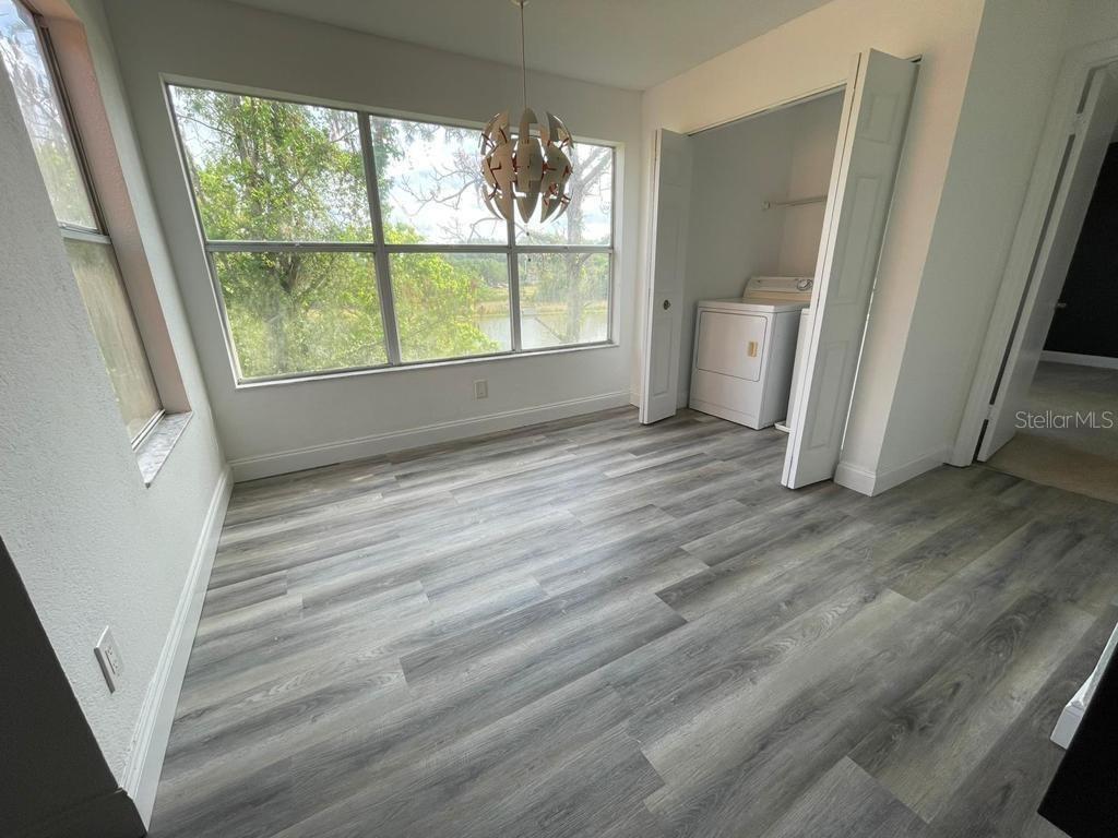 5140 Conroy Road, Unit 37 Orlando, FL 32811 - Photo 3 of 18 wooden floor in an empty room with a window