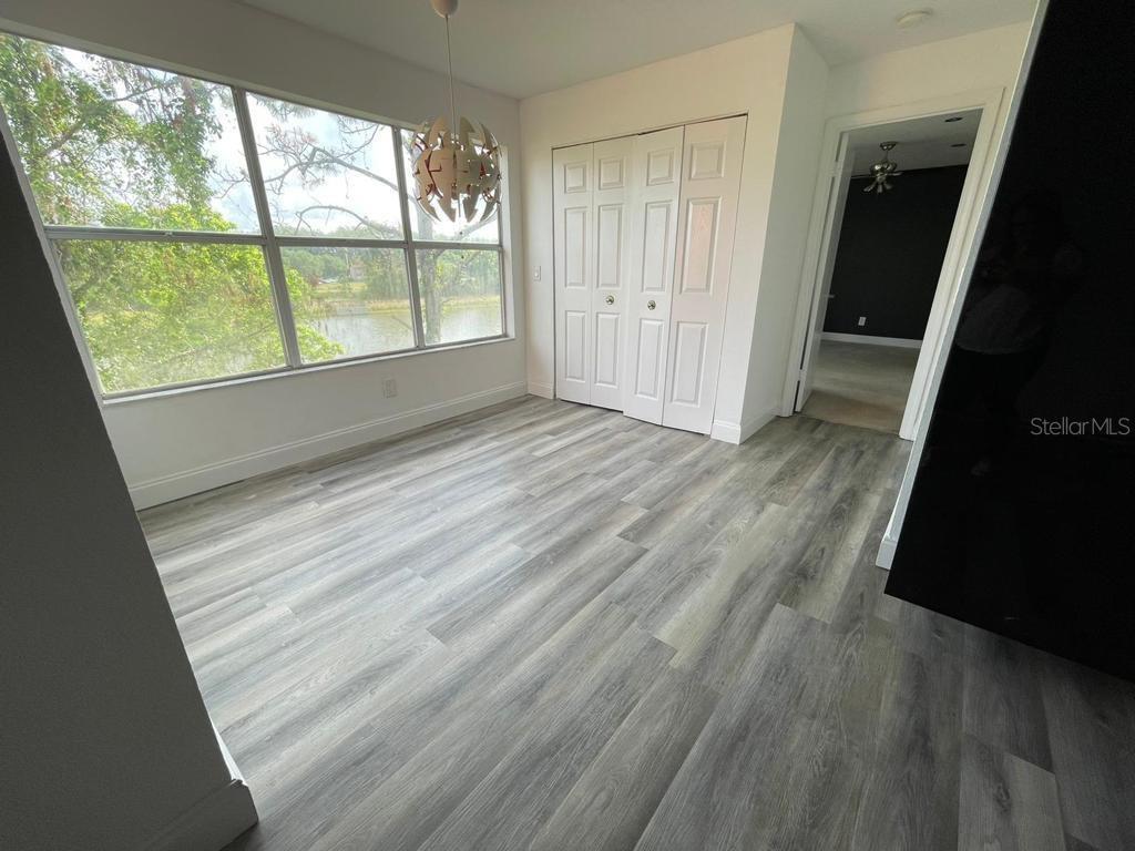 5140 Conroy Road, Unit 37 Orlando, FL 32811 - Photo 5 of 18 a view of wooden floor and windows in a room
