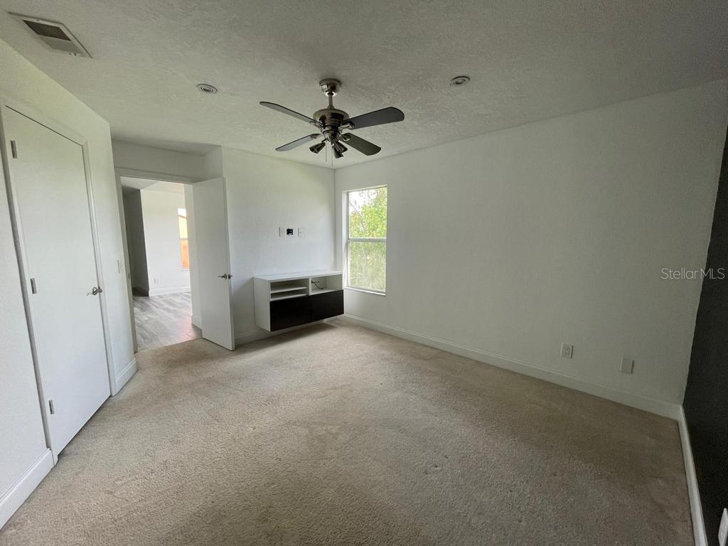 5140 Conroy Road, Unit 37 Orlando, FL 32811 - Photo 10 of 18 a view of a big room with chandelier fan and windows
