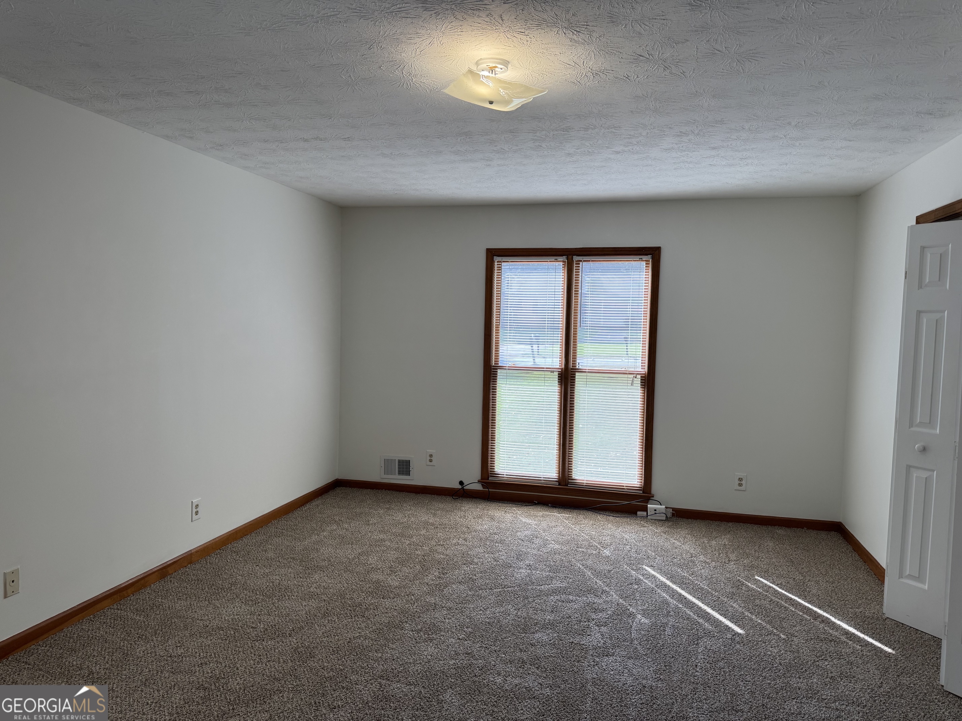 19 Sentry Oak Court, Unit B Stockbridge, GA 30281 - Photo 2 of 14 an empty room with a window
