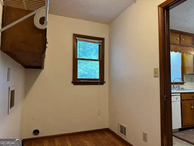 a view of an entryway with wooden floor