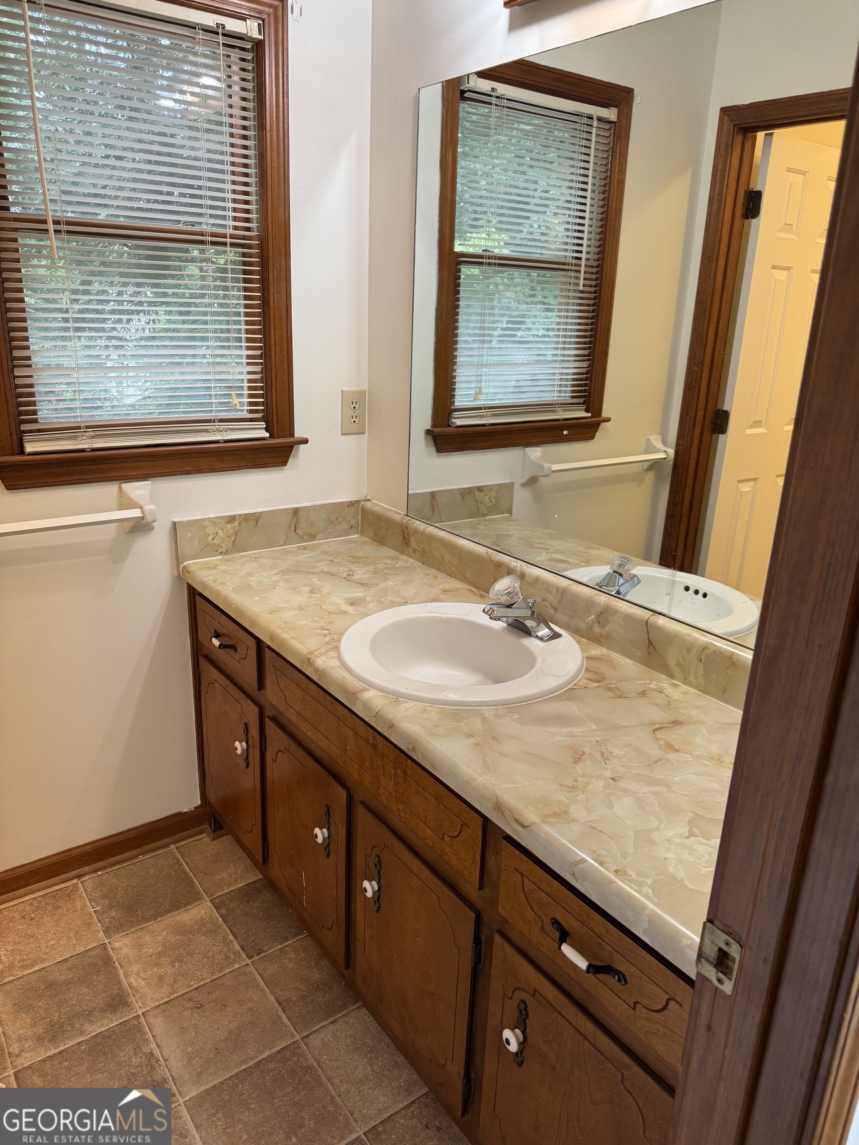 19 Sentry Oak Court, Unit B Stockbridge, GA 30281 - Photo 8 of 14 a bathroom with a granite countertop sink and a mirror