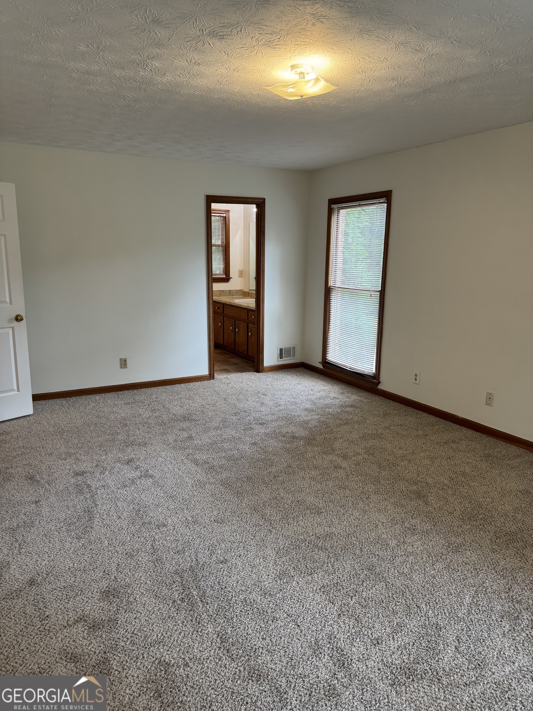 19 Sentry Oak Court, Unit B Stockbridge, GA 30281 - Photo 9 of 14 a view of an empty room with a window