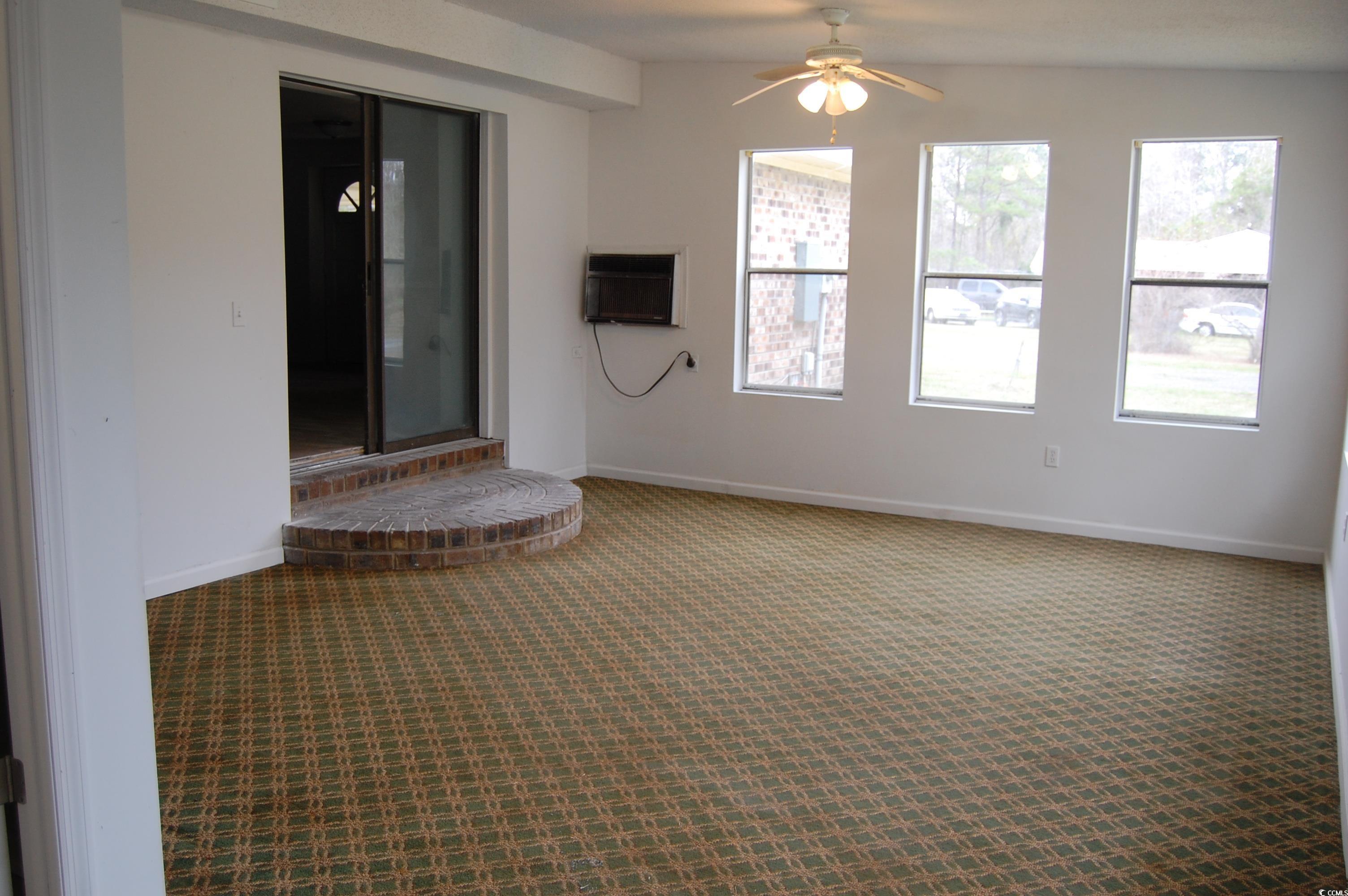 538 County Rd S-22-537 Georgetown, SC 29440 - Photo 33 of 36 Carpeted empty room featuring a wall unit AC, a ce