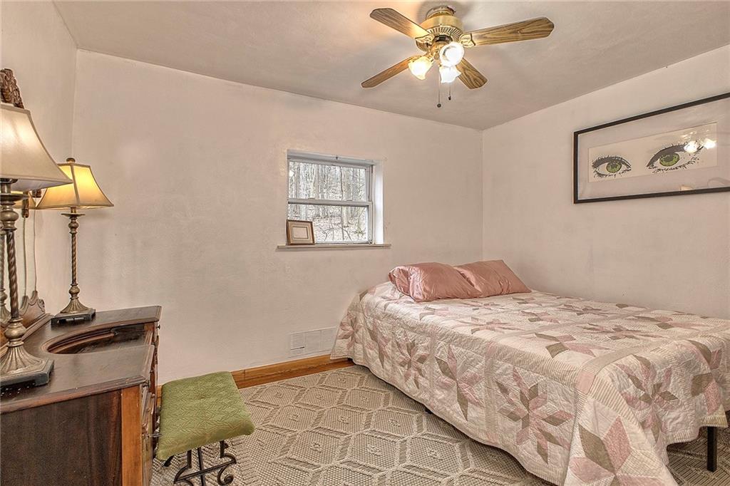 240 Birch Road Acme, PA 15610 - Photo 29 of 44 a bedroom with a bed and a chandelier