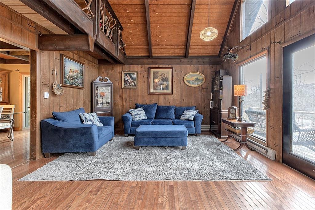 240 Birch Road Acme, PA 15610 - Photo 4 of 44 a living room with furniture and a clock