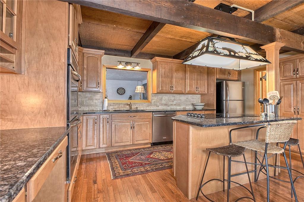 240 Birch Road Acme, PA 15610 - Photo 8 of 44 a open kitchen with stainless steel appliances granite countertop a stove and cabinets