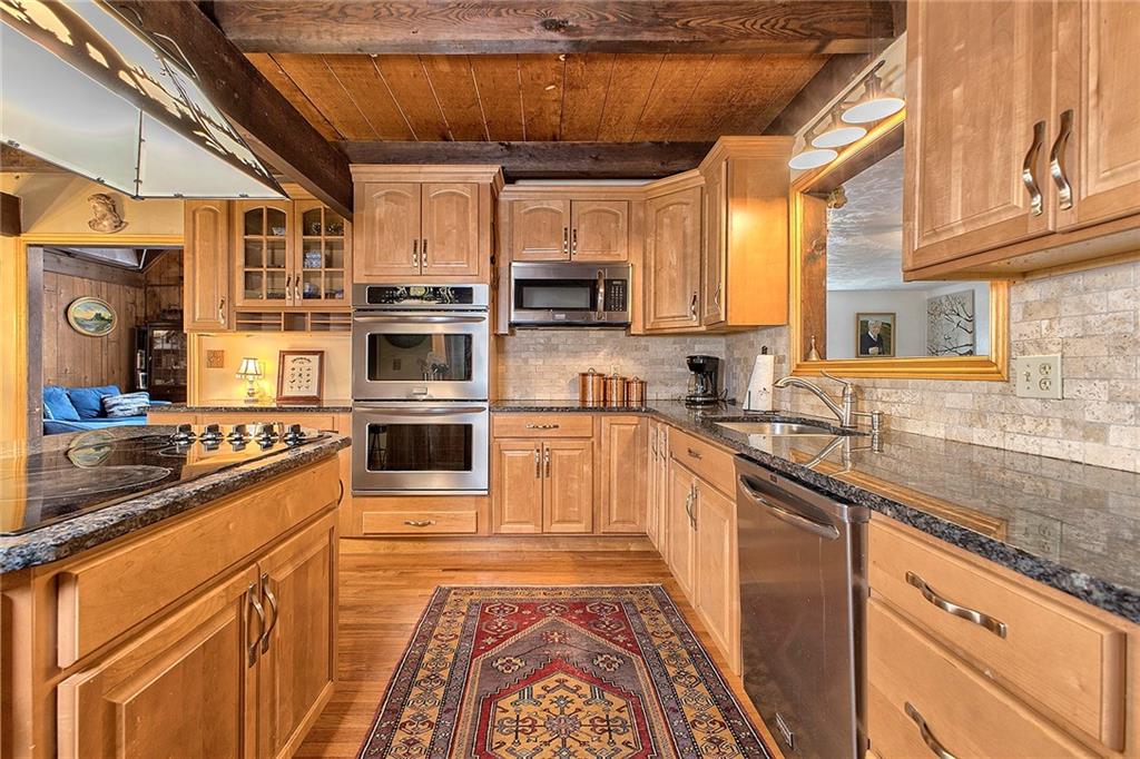 240 Birch Road Acme, PA 15610 - Photo 9 of 44 a kitchen with stainless steel appliances granite countertop a stove and a sink