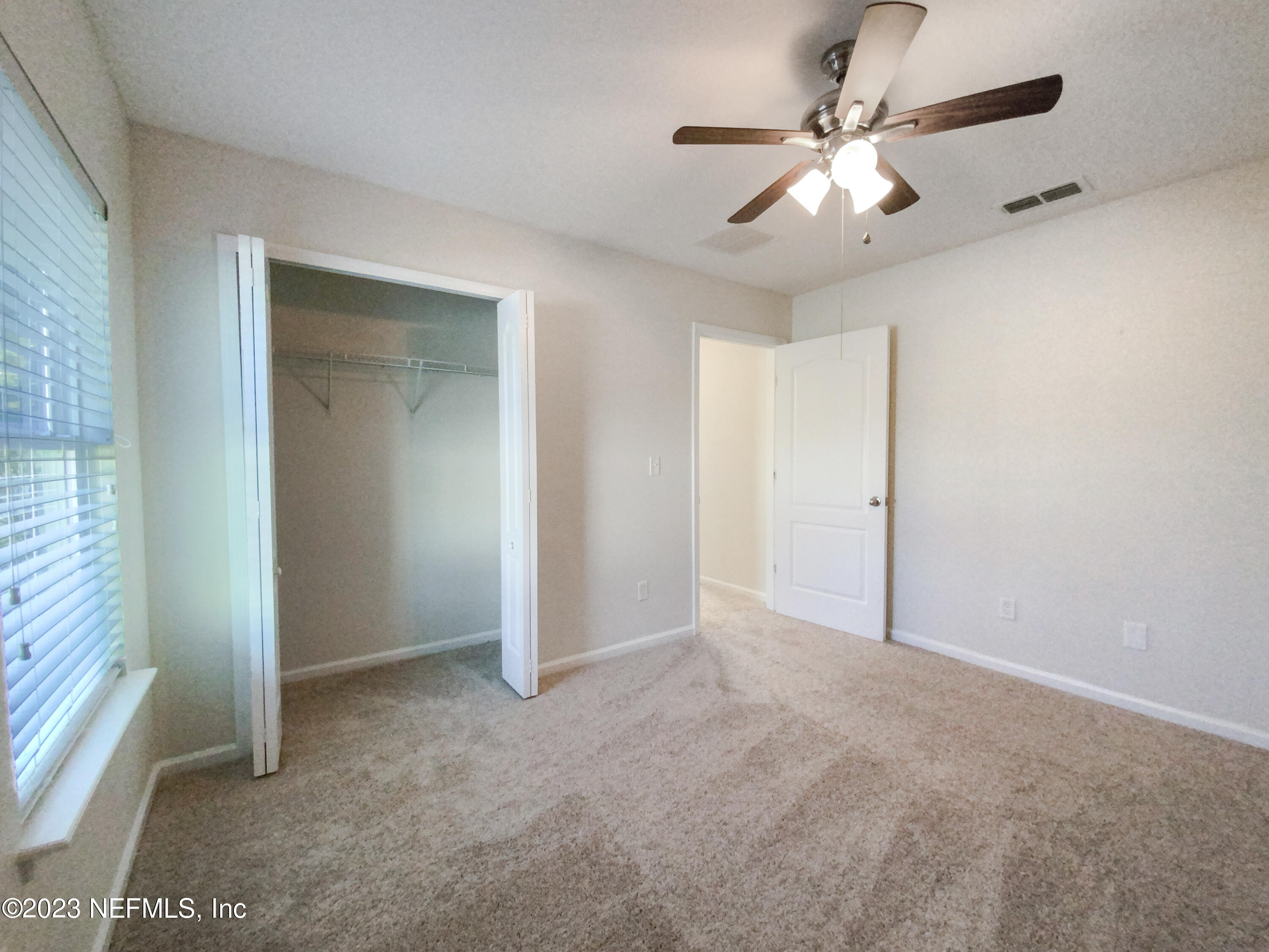 56 Irish Rose Road St. Augustine, FL 32092 - Photo 14 of 25 a view of an empty room with a ceiling fan